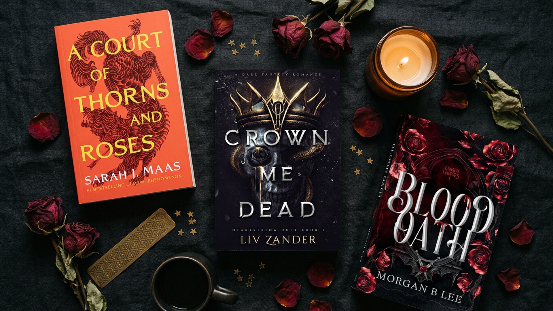 Candlelit flatlay of romance books, dried roses, a brass bookmark and a candle